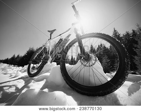Wide View Photo Of Mountain Bike In Deep Snow. Winter Mountains With Road Lost Under Snow.