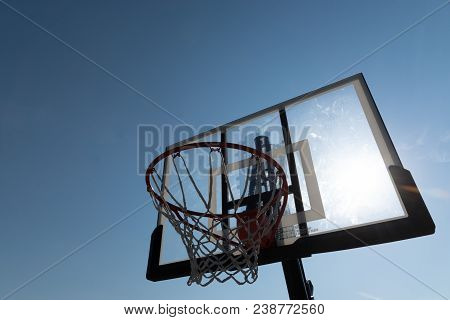 Basketball Hoop Photographed From Below On A Beautiful Summer Day