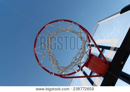 Basketball Hoop Photographed From Below With Blue Sky