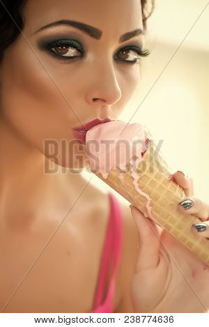 Closeup Of Sexual Attractive Young Lady With Bright Makeup Eating Cold Dessert Of Red Berry Ice Crea