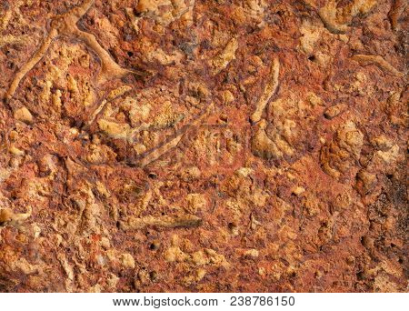 The Textured Surface Of Soil Of The Red Color Put From Sedimentary Limy Breeds With Streaks From Rem