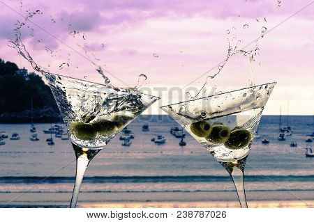 Cocktails With Splashining Martini On A Sunset Beach