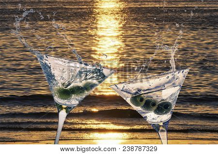 Cocktails With Splashining Martini On A Sunset Beach