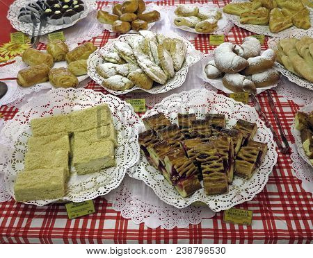On The Tablecloth In A Red Cage A Different Assortment Of Baked Pastries.