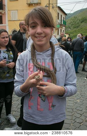 Cocullo, Italy - May 1, 2018: Happy Beautiful Child With Snake In Cocullo For The Serpari Feast, Abr