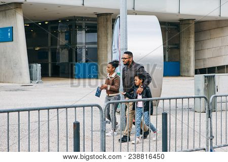 Portugal, Lisbon 29 April 2018: Family Or Tourists Or Company Of Friends Or Group Of People Walk Dow