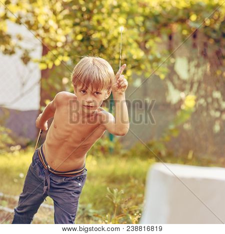 Concentrated Sporty Young Boy Training With Throwing Knife, Image With Square Aspect Ratio And Warm 