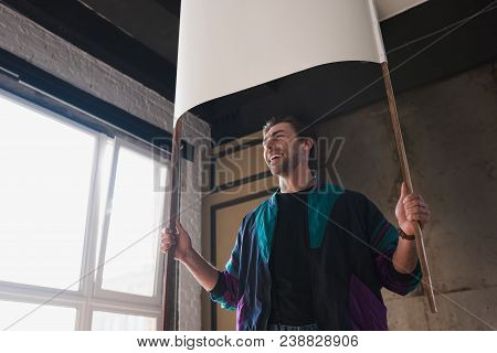 Smiling Young Man In Vintage Windcheater With Blank Placard