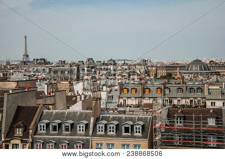 Facade Close-up Of Typical Semidetached Buildings And Eiffel Tower On The Horizon In Paris. Known As