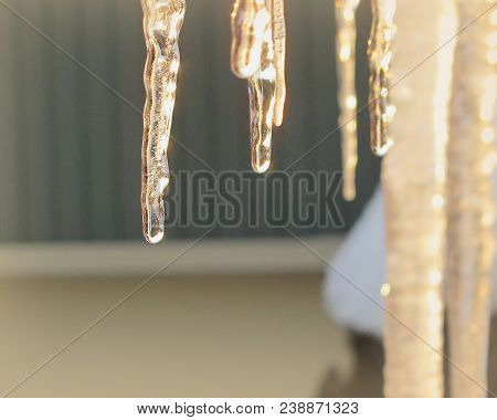 Winter Icicles Hanging From The House Eaves
