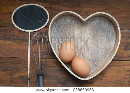 Rustic Kitchen Tools For Bakerry Or Cooking. Raw Eggs With Wooden Spooon And Baking Tools.