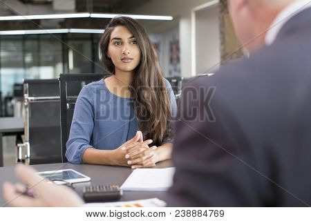 Focused Indian Female Customer Meeting With Financial Advisor. Young Beautiful Candidate At Job Inte
