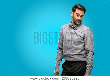 Middle age man, with beard and bow tie having skeptical and dissatisfied look expressing Distrust, skepticism and doubt