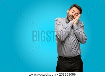 Middle age man, with beard and bow tie tired and bored, tired because of a long day overworking