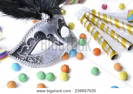 Beautiful Carnival Mask Among Colorful Cotillons On White White Backgroung