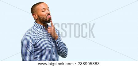 African american man with beard having skeptical and dissatisfied look expressing Distrust, skepticism and doubt isolated over blue background