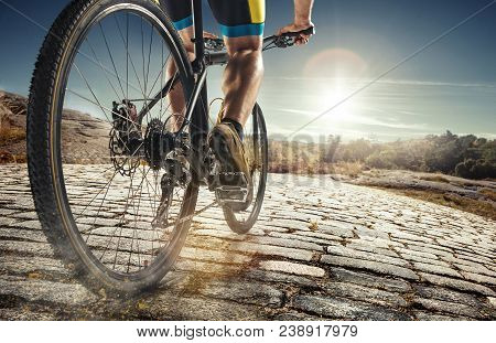 Detail Of Cyclist Man Feet Riding Mountain Bike On Outdoor Trail On Country Road In The Daytime. Bri