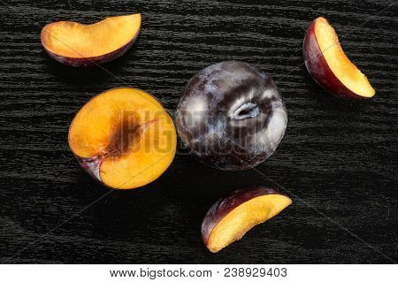 Red Blue Plums Set Table Top Isolated On Black Wood Background One Whole One Section Half Three Slic