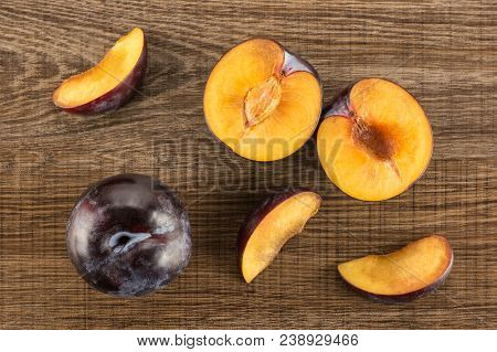 Red Blue Plums Set Table Top Isolated On Brown Wood Background One Whole Two Section Halves Three Sl