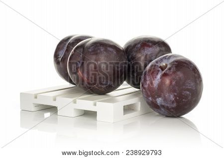 Four Red Blue Plums On A Wood Pallet Isolated On White Background Round Whole Fresh Juicy Fruit