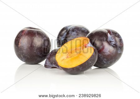 Three Red Blue Plums And Two Halves Isolated On White Background