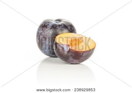 Red Blue Plum With One Sliced Half Isolated On White Background