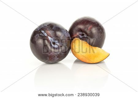Two Red Blue Plums And A Slice Isolated On White Background