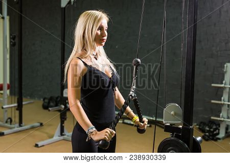 Sport, Fitness, Lifestyle And People Concept - Close Up Of Young Woman Flexing Muscles On Cable Gym 