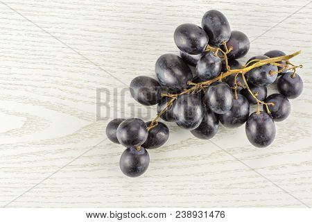 Black Grape Cluster (autumn Royal Variety) Table Top Isolated On Grey Wood Background