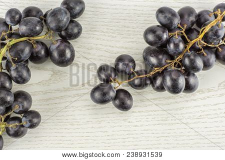 Black Grape Two Clusters (autumn Royal Variety) Table Top Isolated On Grey Wood Background