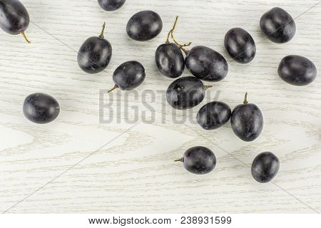 Black Grape Berries (autumn Royal Variety) Table Top Isolated On Grey Wood Background