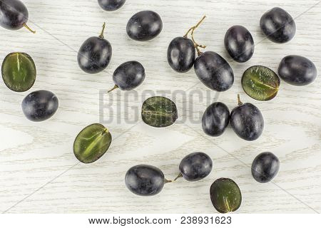 Black Grape Berries (autumn Royal Variety) Table Top Isolated On Grey Wood Background Some Sliced