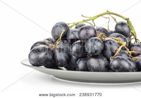 Black Purple Grape Cluster (autumn Royal Variety) On A Grey Ceramic Plate Isolated On White Backgrou