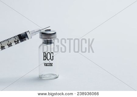 Bottle With An Inscription Bcg And A Syringe On A White Background Close-up. Inoculation From Tuberc
