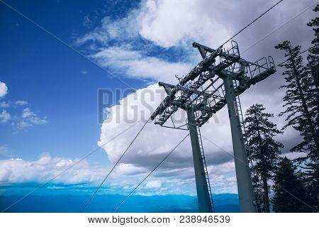 Steel Cable Way Tower Construction, Blue Sky On The Background. Vertical Photo Depicts Mountain Rope
