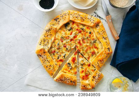 Arabic And Middle Eastern Food Concept. Cheese And Labneh Savory Galette With Olives On A Baking Pap