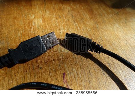Cable With Usb And Microusb Connectors On Wood