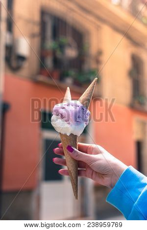 A Woman Sitting And Holding An Ice Cream. Summer Time In The Street Of The Old City