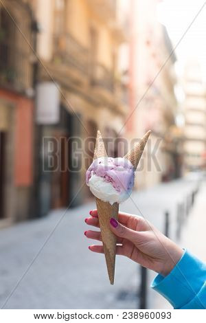 A Woman Sitting And Holding An Ice Cream. Summer Time In The Street Of The Old City. Instagram Toned