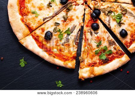 Homemade Napoli Pizza Or Anchovies Pizza On Black Slate Stone