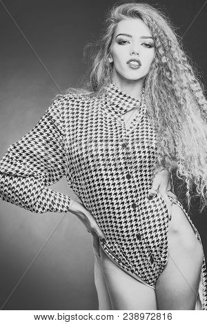 Attractive Radiant Looking Blond Young Woman With Long Wavy Hair Wearing Shirt With Hounds Tooth Pri