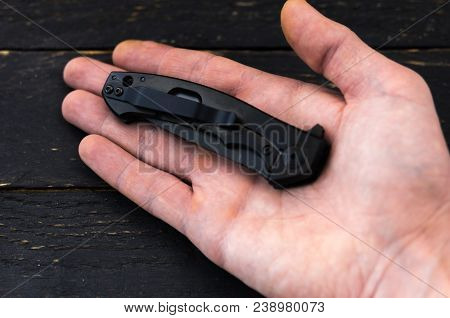 The Knife Is Folded In The Palm Of Your Hand.