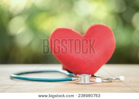 Red Heart And A Stethoscope On A Green Background.