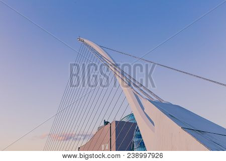 View Of Dublin's Famous Samuel Beckett Bridge Over The River Liffey At Blue Hour