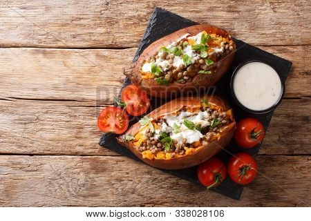 Rustic Style Baked Sweet Potato Stuffed With Lentils, Garlic And Parsley Served With Sour Cream Clos
