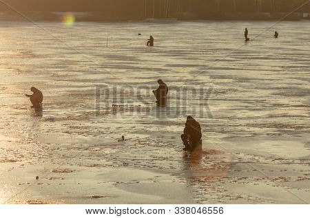 Lipetsk, Russia - December 6, 2019: Guys Catch Fish On Ice In The Morning At The Matyr Reservoir.