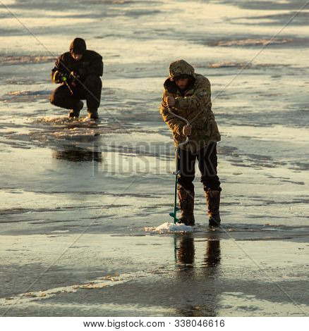 Lipetsk, Russia - December 6, 2019: Two Men Catch Fish On Ice In The Morning At The Matyr Reservoir.