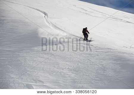 Skier Glides Down The Mountains In Clear Weather