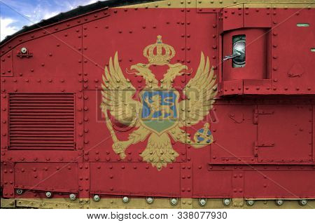 Montenegro Flag Depicted On Side Part Of Military Armored Tank Closeup. Army Forces Conceptual Backg