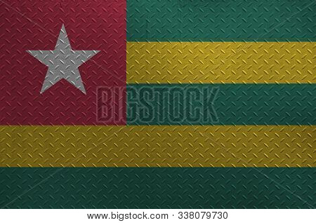 Togo Flag Depicted In Paint Colors On Old Brushed Metal Plate Or Wall Closeup. Textured Banner On Ro